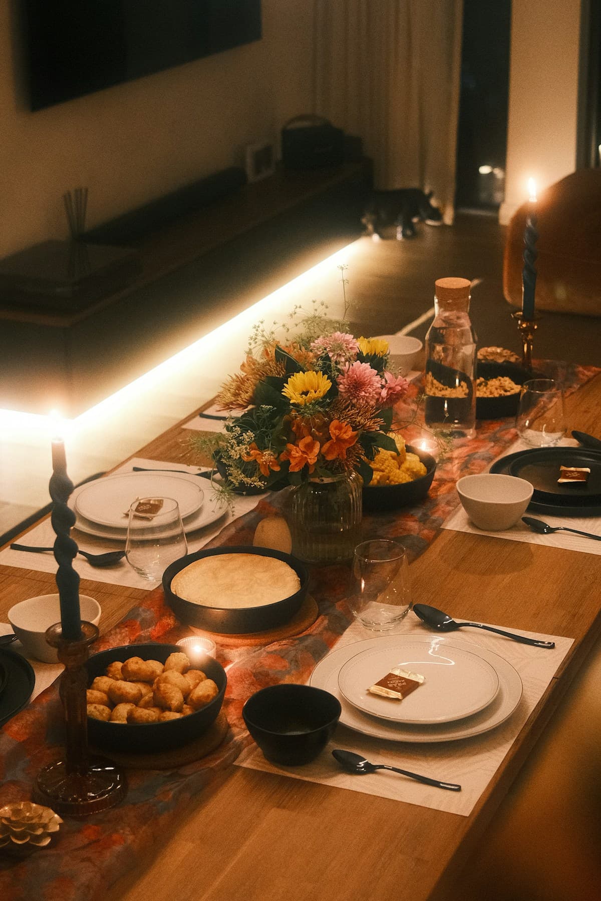 Set table with candles, flowers and plates — intimate evening atmosphere